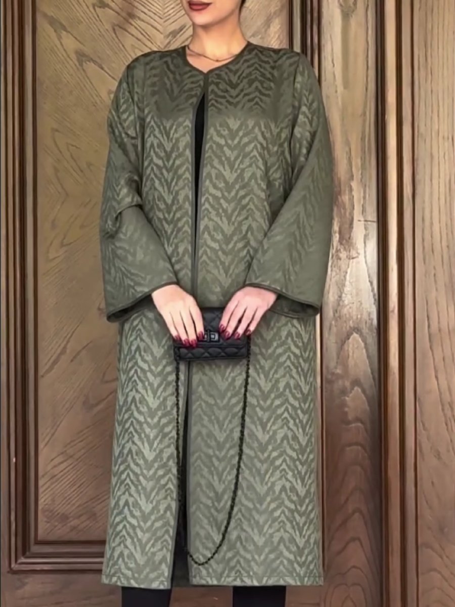 A textured all-over patterned green jacket